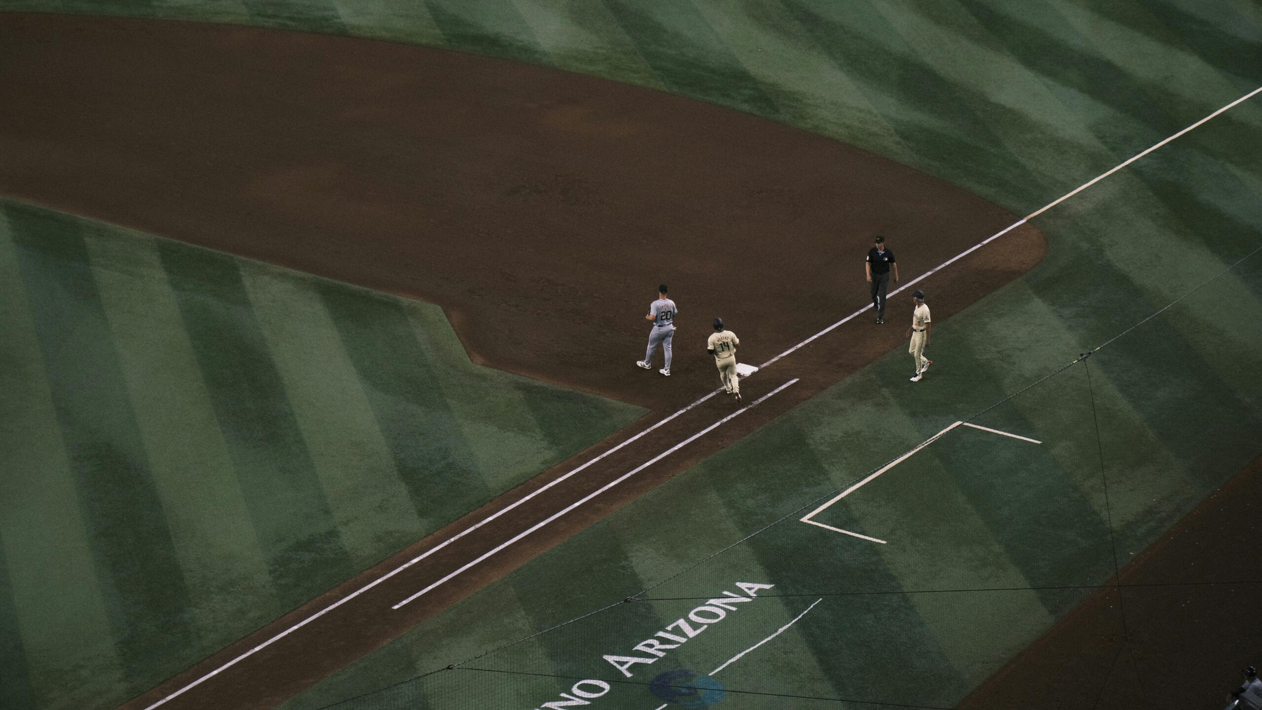 Baseball players on field at Chase Field, Arizona, captured from above.