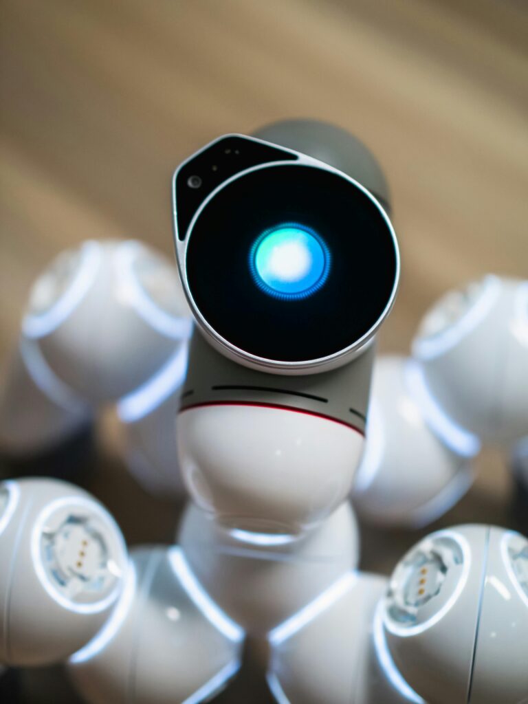 Close-up view of a humanoid robot with a glowing blue eye, symbolizing advanced technology.